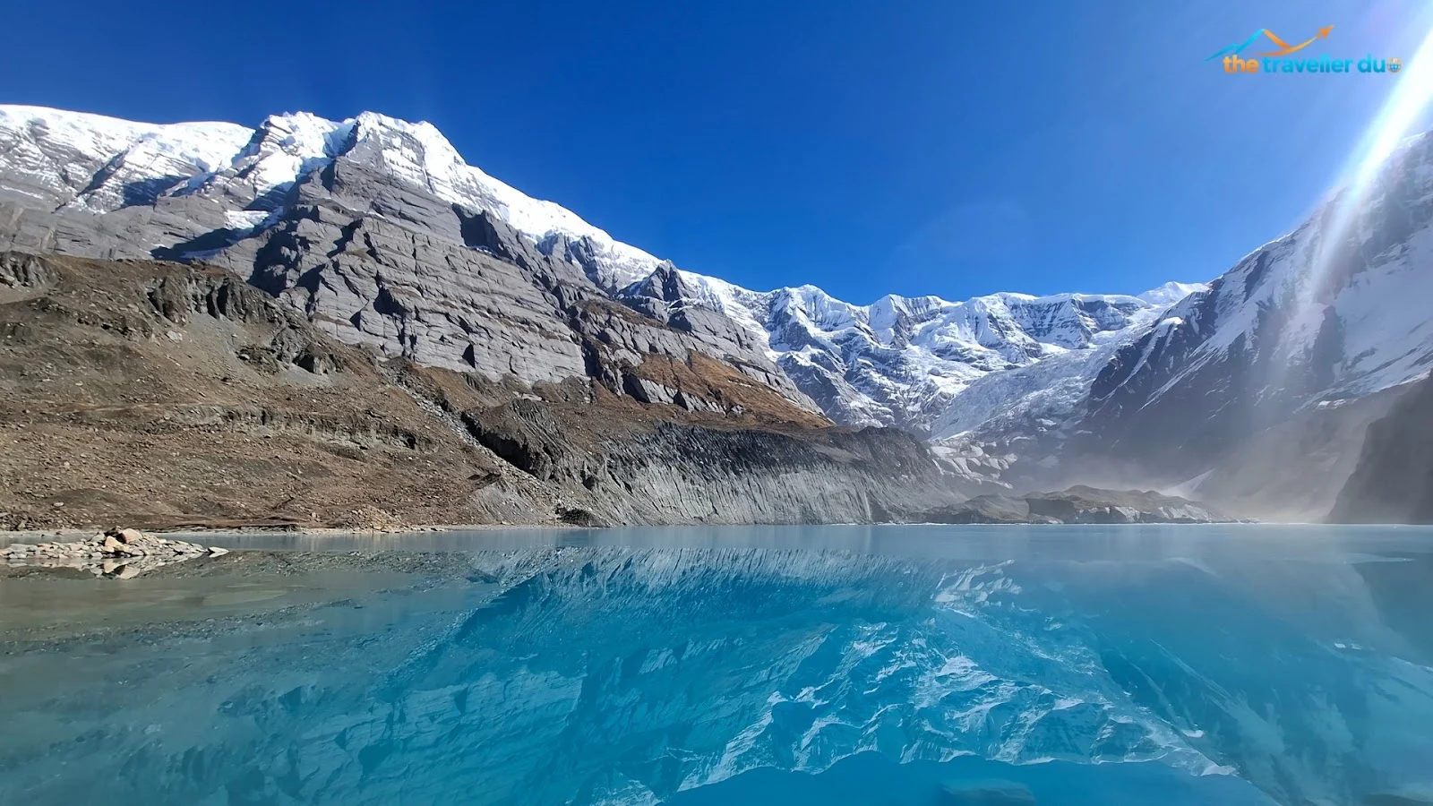 Turquoise Panchakunda Lake reflecting snow-covered Annapurna range peaks at about 4,050 m in Myagdi